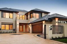 a large house with two garages and an attached walkway leading to the front door