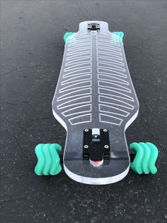 a skateboard with green wheels on the pavement