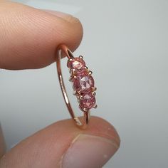 14K Solid Gold Triple Rose Cut Ring Band Thickness 1.4mm Made With Rose Cut Pink Sapphires If you looking another stones send message to me :) Center stone is 4.5mm, and side stones are 3.5mm ▶ If you like it don't forget to look our ring designs :) * https://www.etsy.com/listing/995975965/triple-rose-rose-cut-white-sapphire-ring?ref=shop_home_active_19&pro=1&frs=1 * https://www.etsy.com/listing/1084039268/triple-rose-rose-cut-blue-sapphire-ring?ref=shop_home_active_8&pro=1&frs=1 * https://www.e 14k Rose Gold Sapphire Gemstone Ring Gift, 14k Rose Gold Sapphire Ring Gift, Delicate 14k Gold Pink Ring, Pink Ruby Ring In 14k Rose Gold, Rose Gold Sapphire Ring With Prong Setting For Promise, 14k Rose Gold Jewelry For Proposal, Delicate Pink 14k Gold Rings, Delicate 14k Rose Gold Rings, 14k Rose Gold Jewelry With Rose Cut Diamonds