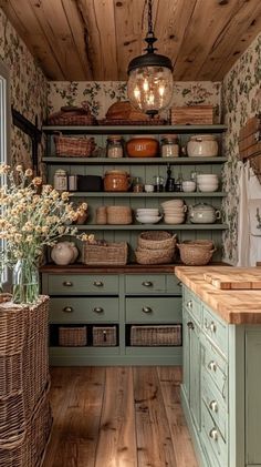 an old fashioned kitchen with green cabinets and baskets on the shelves, along with wicker baskets