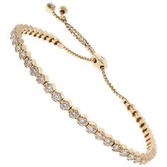 Nothing says luxury and sophistication like this spectacular diamond eternity bolo tennis bracelet. A total of 45 round brilliant cut diamonds are prong set eternity style, sparkling in the rich 14 karat yellow gold with a total weight of 2.01 carats. This diamond bolo bracelet is adjustable in length with shiny slide bead and can accommodate most average wrist sizes and is perfect as an anniversary or birthday gift. Round Diamond Bracelet, Round Bracelet, Retro Bracelet, Bracelet Tennis, Diamond Eternity, Tennis Bracelet, Round Brilliant Cut Diamond, Round Brilliant Cut, Brilliant Cut Diamond