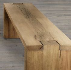 a wooden bench sitting on top of a hard wood floor