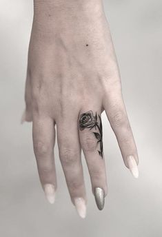 a woman's hand with a tattoo on it