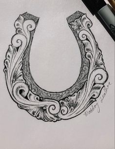 a drawing of a horseshoe with swirls on it