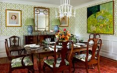 a formal dining room with green and white wallpaper