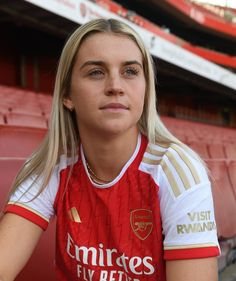 a female soccer player is posing for a photo