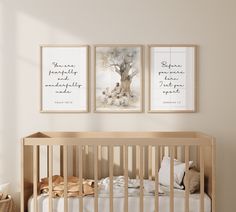 a baby crib with two pictures hanging on the wall