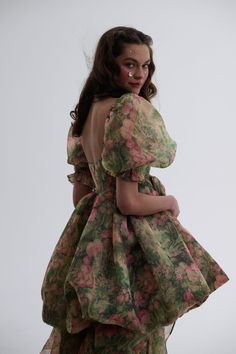 This organza bubble puff gown in our Castle Tapestry print transforms you into a walking masterpiece. The lush green antique pattern, inspired by French Victorian textiles, adorns two layers of organza with bustle loops for an adjustable train. Sheer puff sleeves complete this wearable art piece, perfect for gliding through art galleries or capturing twilight moments outside the Louvre. We suggest pairing with The Castle Tapestry A La Mode Corset. Organza bubble puff gown with adjustable bustle Victorian Textiles, Puff Gown, Castle Tapestry, Tapestry Print, Antique Pattern, Fairytale Gown, Green Antique, French Victorian, Skirt Swimsuit