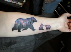 a woman's arm with a bear and cubs tattoo on the left inner forearm