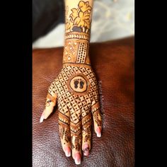 a woman's hand with henna tattoos on it