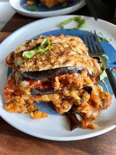 an eggplant lasagna on a plate with a fork