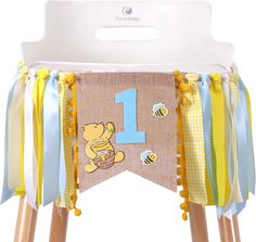 the first birthday banner is decorated with winnie the pooh and his honeybees