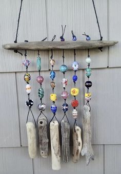 a wind chime hanging on the side of a building with lots of glass beads