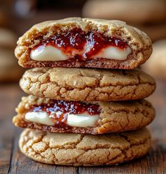 three cookies stacked on top of each other with jam and cream in the middle one