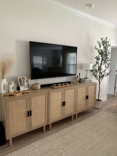 a flat screen tv sitting on top of a wooden cabinet