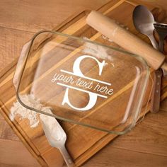 a personalized glass dish on a cutting board with utensils