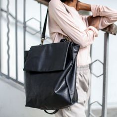 "100% Handmade Gorgeous and practical Black leather backpack / shoulder bag in a unique geometric cut with asymmetric details . This bag has a minimalistic and timeless form which makes it functional as a tote as well as backpack. It is made for a long day out of the house as well as a night out where you can carry your essentials plus laptop, a sweater, sunglasses etc... Fully lined with black strong cotton fabric which I divide to two large interior (one for laptop), large zip pocket, and a le Leather Laptop Tote, Small Leather Backpack, Soft Leather Backpack, Laptop Backpack Women, Leather Hip Bag, Large Leather Bag, Brown Leather Backpack, Backpack Laptop, Laptop Bag For Women