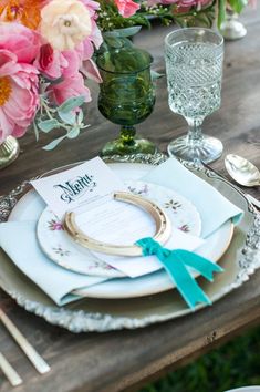 the table is set with plates and place settings