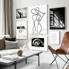 a living room filled with furniture and pictures on the wall