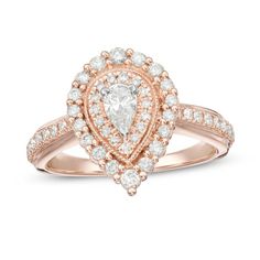 a pear shaped diamond ring set in rose gold with white diamonds on the shoulders and sides