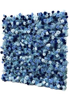 blue and white flowers are arranged on the wall