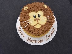 a birthday cake with a lion face on it's side and the words happy birthday zany