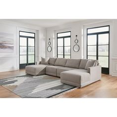 a living room with large windows and a sectional couch