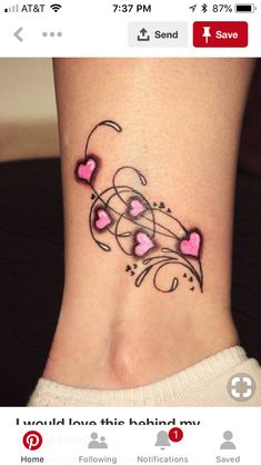 a woman's foot with hearts and swirls on the side, tattoo style