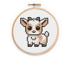 a cross stitch pattern with a small dog on it's face in the hoop