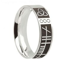 a stainless steel ring with black and white symbols