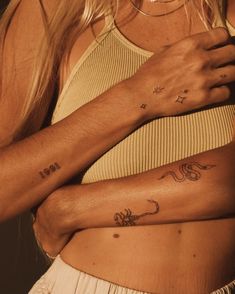 two women with matching tattoos on their arms