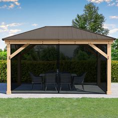 a gazebo with chairs and tables in the middle of a lawn area next to bushes