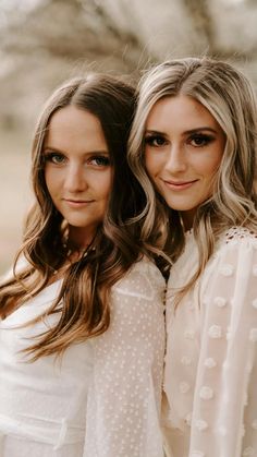 two beautiful women standing next to each other