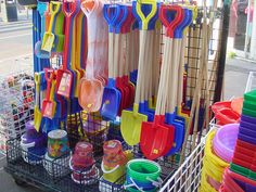 a cart filled with lots of colorful plastic utensils