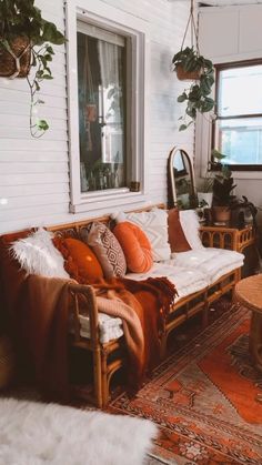 a living room filled with furniture and plants