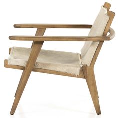 a wooden chair with sheepskin on it