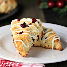 a piece of cake sitting on top of a white plate next to a christmas tree