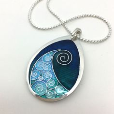 "Aqua Teal Wave Pendant - Cloisonné & Champlevé Enamel Necklace on Fine Silver with 18\" Sterling Silver Chain Sandra McEwen Designs Materials: Champlevé & cloisonné Enamels on Fine silver. Pendant Size: 1\" x 1.5\" Includes an 18\" Sterling Silver chain ------------------------------------------------------------------------------------------------ Did you know that enamels are melted glass? Yes! It's true... To create this lovely pair of earrings, I first fabricated the silver base out Diy Resin Earrings, Enameling Jewelry, Cloisonne Enamel Jewelry, Wave Pendant, Cloisonne Jewelry, Wilmington North Carolina, Wrist Jewelry, Enamel Necklaces, Cloisonne Enamel