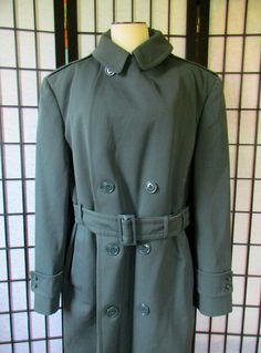 Excellent vintage army overcoat with a separate lining in like new condition. Seems hardly worn. The fabric is wool gabardine. Zip in lining is nylon upper section and a lower section that is flannel. Labeled AG-44, DSA100-67-C-1691. I am not sure of the dating on this coat, its possibly Vietnam era. Labeled 40R, but please note measurements: Chest is 44/45 inches and hips are 44 inches. Sleeve is 25 inches. Shoulder seam to seam is 19-1/4 inches. Length is 45 inches. 2 button pockets in front. Military Wool Double-breasted Pea Coat, Military Style Wool Outerwear In Khaki, Military Style Long Business Coat, Military Style Long Coat For Business, Classic Khaki Wool Pea Coat, Military Style Wool Pea Coat For Work, Military Wool Pea Coat For Work, Wool Military Pea Coat For Work, Military Style Formal Winter Pea Coat