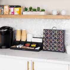 the coffee bar is organized with cups and other items