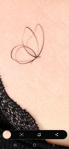 the back of a woman's shoulder with a small butterfly tattoo on her left side