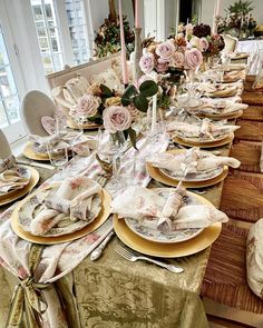 the table is set with many plates and place settings