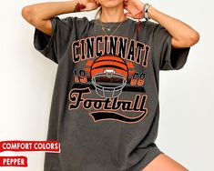 WELCOME TO MY STORE ♥️ This Vintage Cincinnati Benga Football Comfort Colors T-Shirt / Sweatshirt, Vintage Style Cincinnati Football Sweatshirt, Bengal Fan Gift Shirt. _UNISEX COMFORT COLORS T-SHIRT *The Comfort Colors tee is made with medium fabric (6.1 oz/yd² (206.8 g/m consisting of high quality, 100% ring-spun US cotton for long-lasting comfort. *Made using 100% US cotton that is ethically grown and harvested. *All Comfort Colors shirts feature pre-shrunk cotton for size retention. *Care ins Bengal Shirt Ideas, Cute Bengals Shirt, Vintage Bengals Sweatshirt, Bengals Hoodie, Cincinnati Bengals T Shirts, Sweat Vintage, Football Sunday, Football Sweatshirt, Comfort Colors Sweatshirt