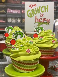 cupcakes with green frosting and dr seuss's grin on top