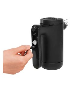 a person is opening the door to a black coffee pot on a white background and holding it in their hand