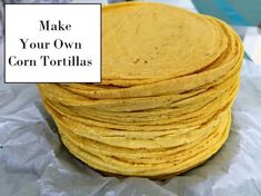 a stack of corn tortillas sitting on top of a piece of wax paper