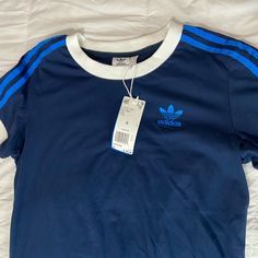 Brand New , With Attached Tags. Size Small Style : 3 Stripes Tee I’m 4’10. Adidas Blue Three Stripes Top, Adidas Blue Tops With Three Stripes, Blue Adidas Tops With Three Stripes, Casual Navy Tops With Three Stripes Branding, Blue Three Stripes Tops For Summer, Blue Cotton Tops With Three Stripes, Spring Adidas Three Stripes Top, Adidas Blue Tops With Three Stripes Branding, Blue Adidas Tops With Three Stripes Branding