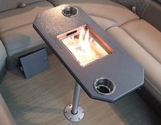 the inside of a boat with a fire place on it's center console area