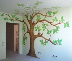 a tree painted on the wall with green leaves