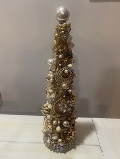 a decorative christmas tree made out of old watch parts